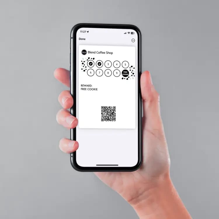 A customer holding a Blend Coffee Shop loyalty card in their phone wallet